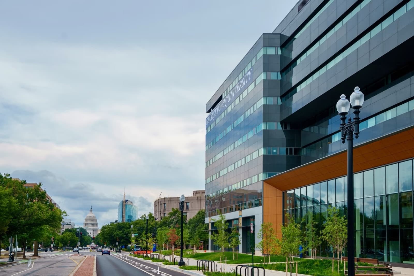 Georgetown University Capitol Campus exterior at 111 Massachusetts Avenue NW, with the U.S. Capitol in the distance